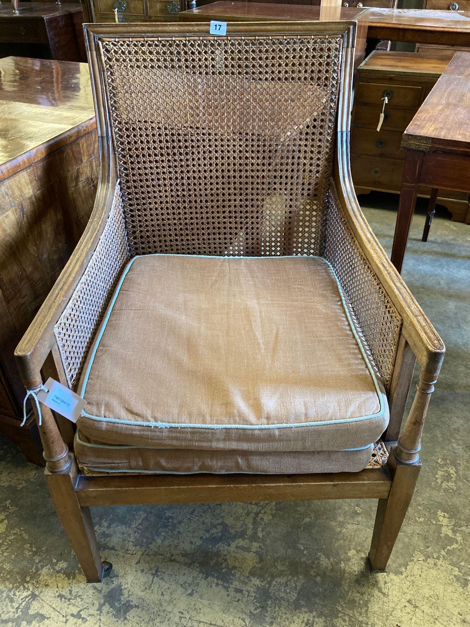 An Edwardian Regency style beech bergere armchair, with caned back and sides, width 60cm